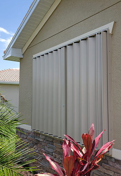 Our products: Accordion Shutters Custom accordion hurricane shutters on a home in Fort Myers – Shutter Specialists