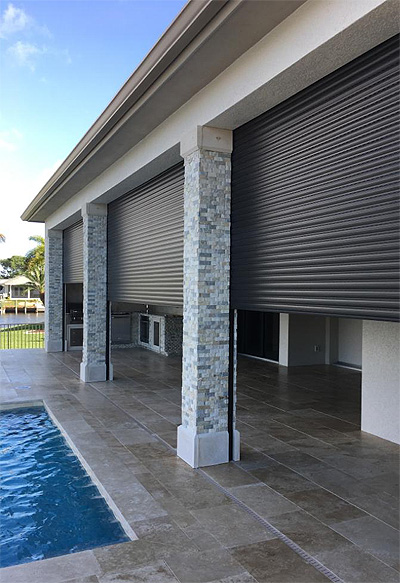 Our products: Rolldown Shutters Motorized roll-down storm shutters on a lanai in Naples – Shutter Specialists